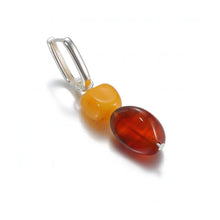 Silver loop pendant with polished yellow and deep amber beads on white background