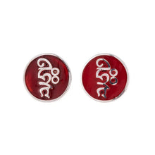 Round red enamel stud earrings with silver abstract design on white background