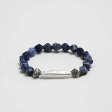 Bracelet with faceted blue sodalite beads and central elongated white pearl with silver accents