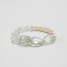 Elegant bracelet featuring large clear crystal beads and soft pink pearls on white background