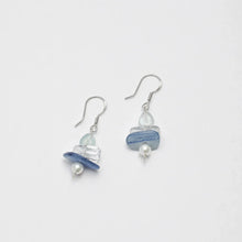 Elegant dangle earrings with blue stone, clear bead, and white pearl on silver hooks