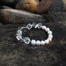 Bracelet with clear geometric beads and white pearls on dark textured stones