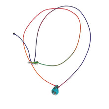 Colorful adjustable string necklace with turquoise stone pendant on white background