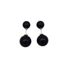 Black double bead stud earrings with smaller bead on front and larger bead behind earlobe on white background