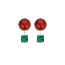 Fashion earrings with round red marbled balls and rectangular green striped pendants on gold studs