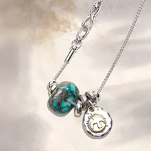 Silver chain necklace with turquoise bead and silver sun charm with gold sun design