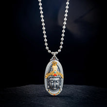 Silver pendant necklace featuring a detailed Buddha face with gold and colorful stone accents