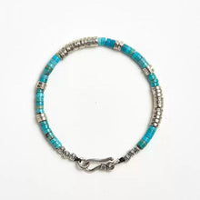 turquoise and silver beaded bracelet with hook clasp on white background
