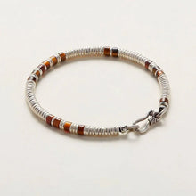 Silver and brown beaded bracelet with unique clasp on white background