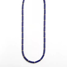 Elegant necklace with cylindrical deep blue beads separated by small gold spacer beads
