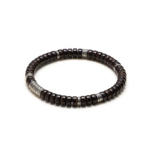 Close-up of a dark brown wooden bead bracelet with silver spacers on a white background