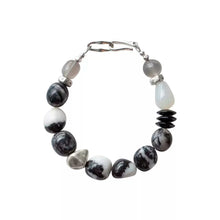 Black and white beaded bracelet with irregular stones and silver clasp on white background