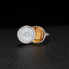 Silver ring with jade cover revealing detailed golden Thousand-Armed Avalokiteshvara statue inside